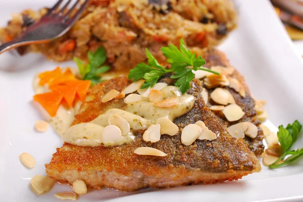 Fried carp with almonds and sauerkraut for christmas eve — Stock Photo, Image