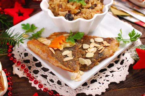 Fried carp with almonds and sauerkraut for christmas eve — Stock Photo, Image