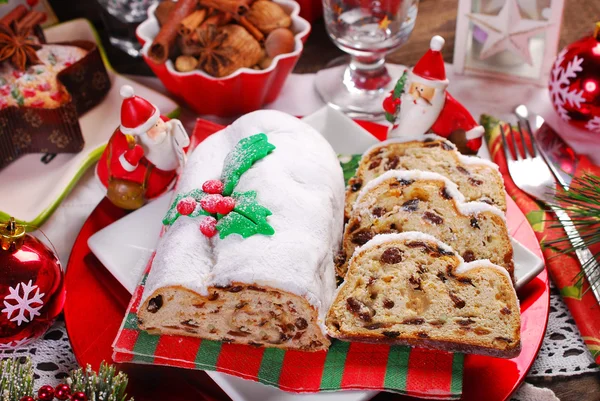 Christmas stollen cake on festive table — Stock Photo, Image