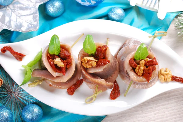 Appetizer of herring rolls with dried tomato and walnuts for chr — Stock Photo, Image