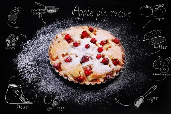 Apple pie with cranberry and drawing recipe on black table — Stock Photo, Image