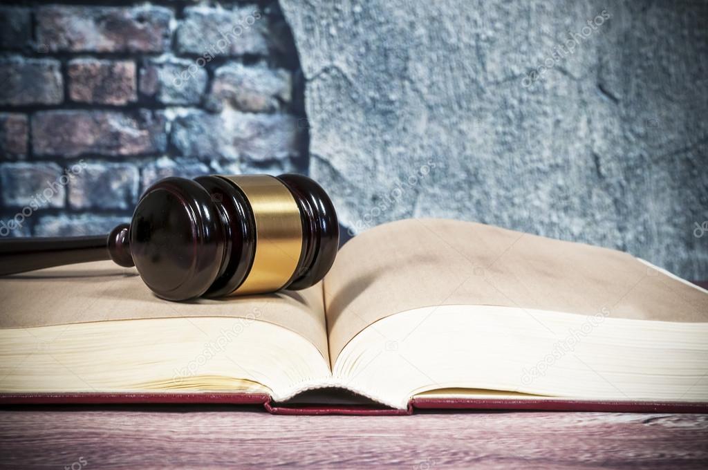 judges gavel and  book on wall background