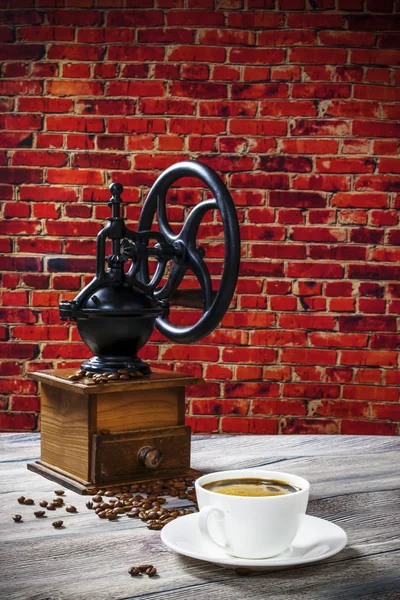 Coffee grinder on the background of brick wall — Stock Photo, Image