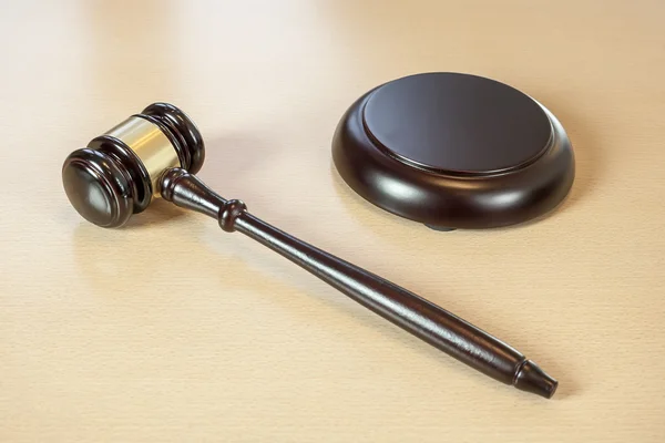 A wooden gavel on wooden table, on brown background — Stock Photo, Image