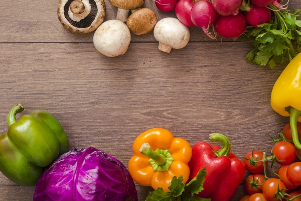 Various vegetables in a circle on the wooden floor Royalty Free Stock Photos