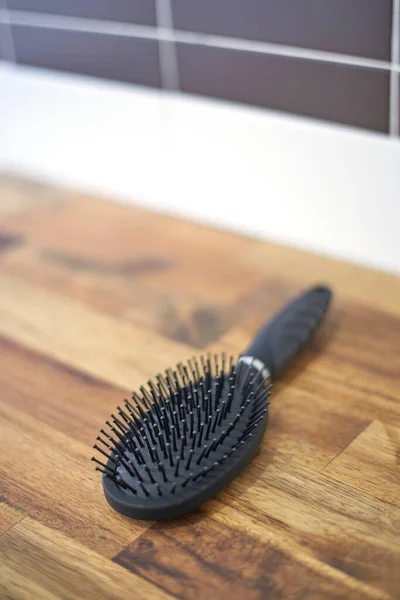 A studio photo of a hair brush