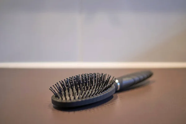 A studio photo of a hair brush