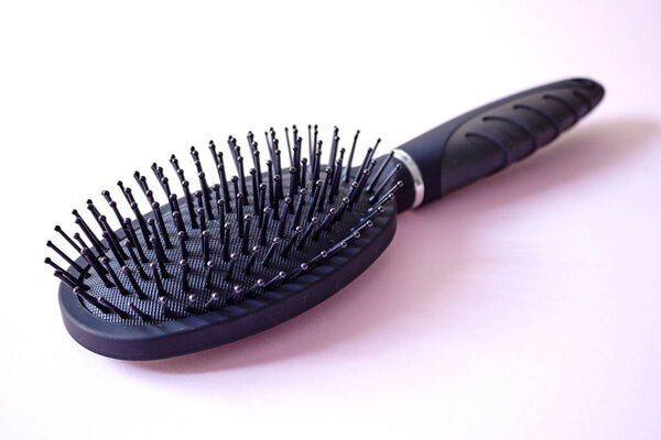 A studio photo of a hair brush