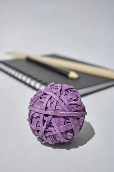 A studio photo of a rubber band ball