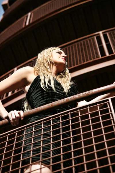 Blonde woman on balcony — Stock Photo, Image