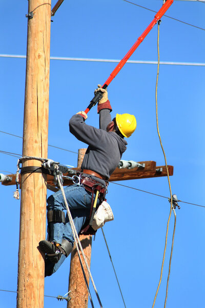Electrical lineman working on line