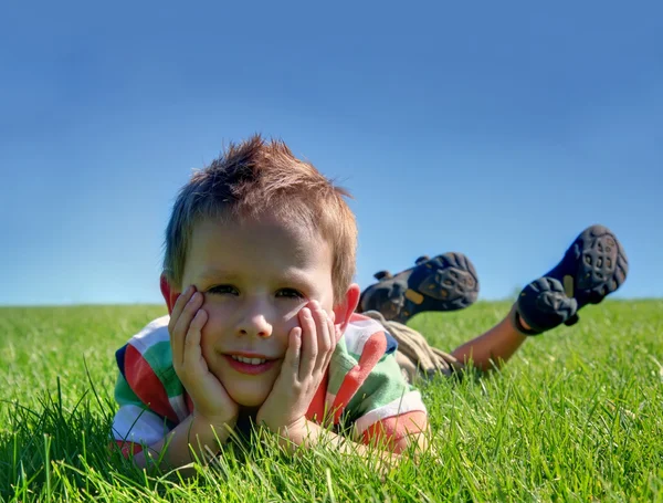 Boy laying in the grass — Stock Photo, Image