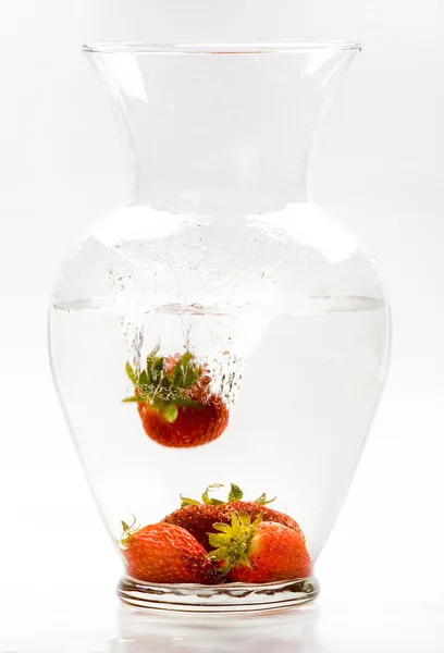 Strawberries drop into glass jar — Stock Photo, Image