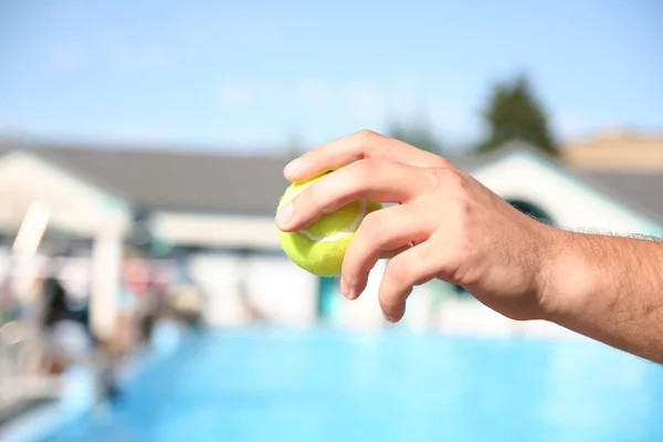 Person holding a tennis ball — Stock Photo, Image
