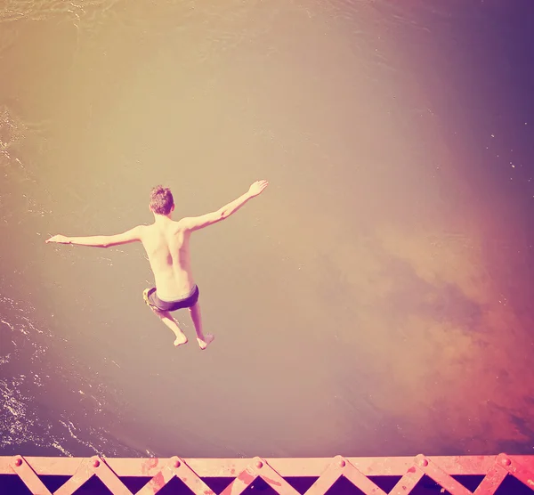 Boy jumping into river — Stock Photo, Image