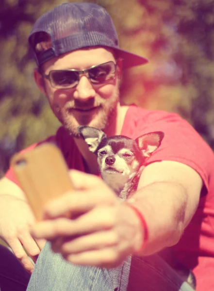 Guy with dog smiling at camera — Stock Photo, Image