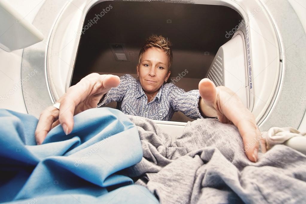 Woman reaching in a dryer