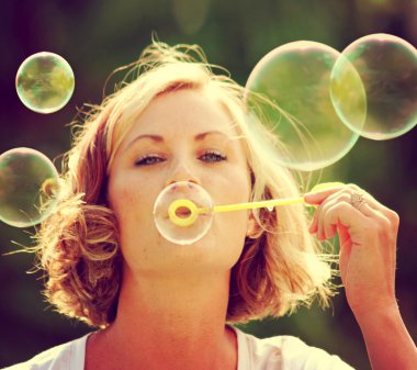 Kadın parkta kabarcıklar üfleme