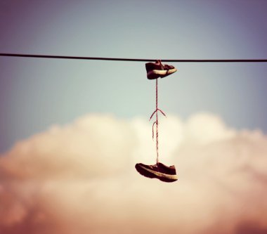 Sneakers hanging from electrical wire clipart