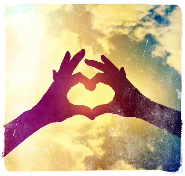 Two hands making heart shape in sky — Stock Photo, Image