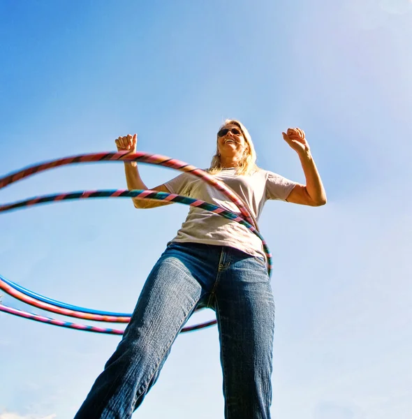 Donna felice filatura Hula Hoops — Foto Stock