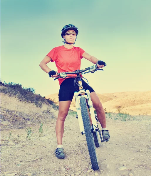 Girl on bike in hills — Stock Photo, Image