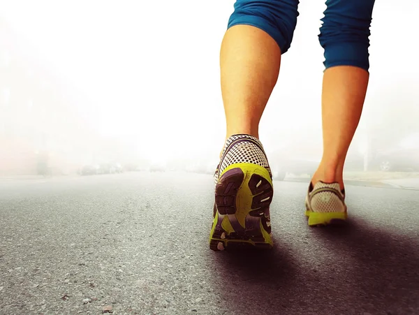 Athletic pair of legs on pavement — Stock Photo, Image