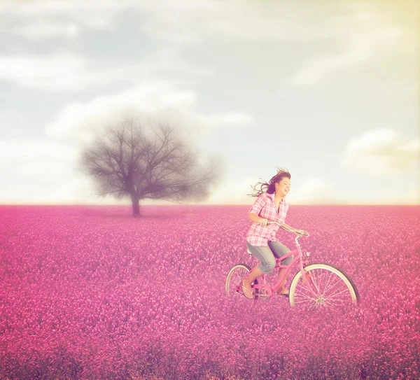 Field with a woman riding through — Stock Photo, Image