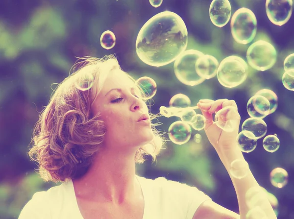 Mulher bonita soprando bolhas — Fotografia de Stock