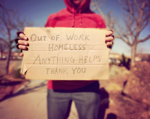 Homeless person with sign