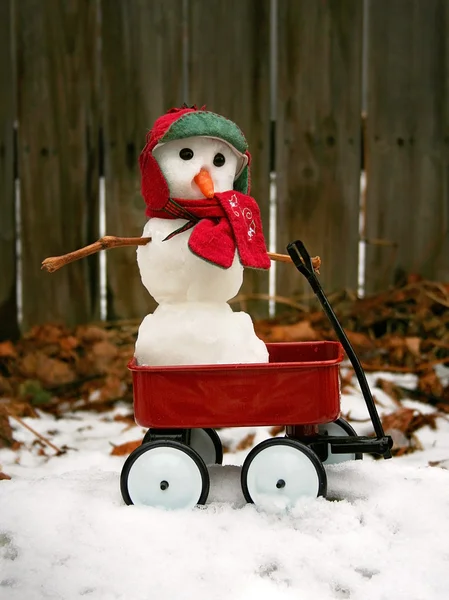 Miniatur-Schneemann im roten Wagen — Stockfoto