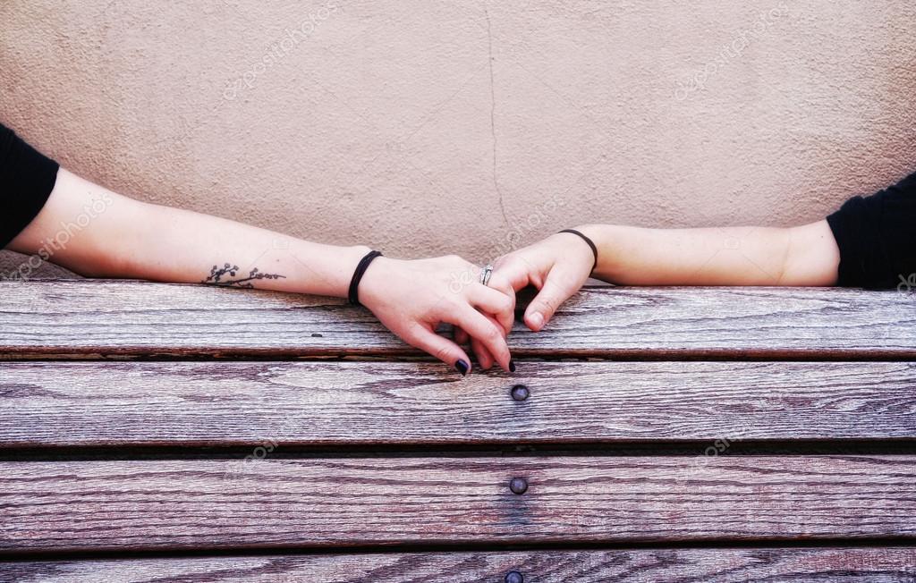 People holding hands on bench — Stock Photo © graphicphoto 53620555