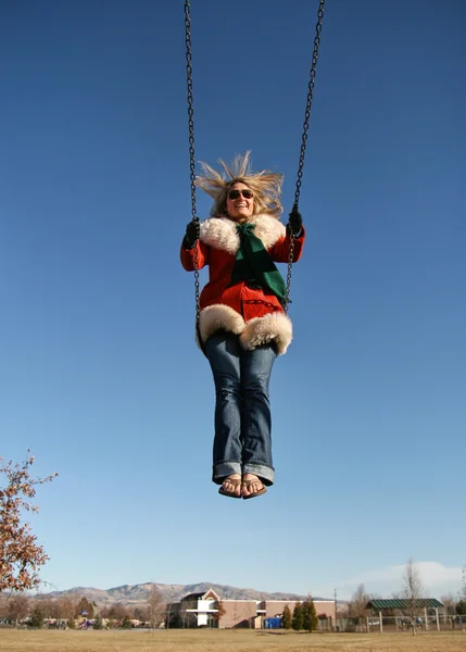 Pretty woman on a swing — Stock Photo, Image