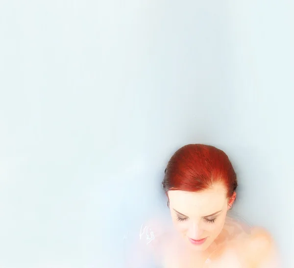 Red haired girl in a pool — Stock Photo, Image