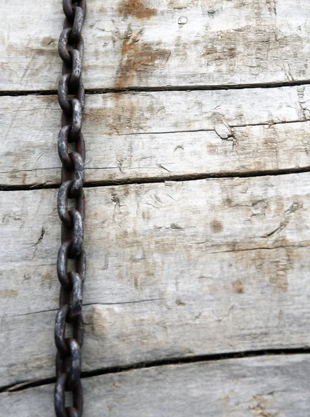 Big chains on the brown wooden background — Stock Photo, Image