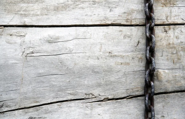 Big chains on the brown wooden background — Stock Photo, Image