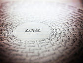 Word love written on lined paper