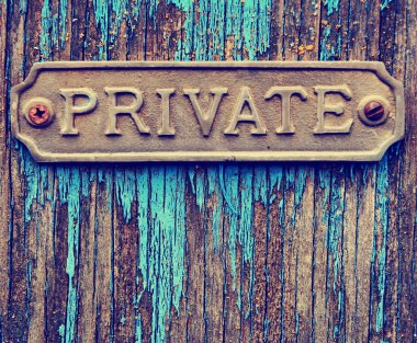 Private sign on old wooden door clipart