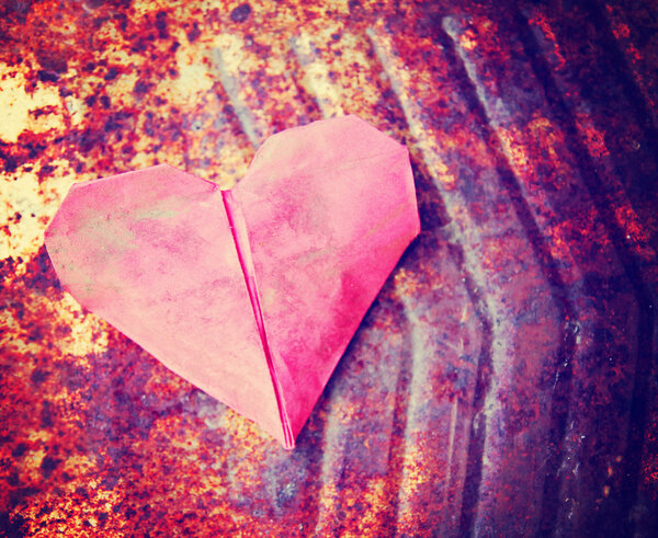Paper heart on rusty background