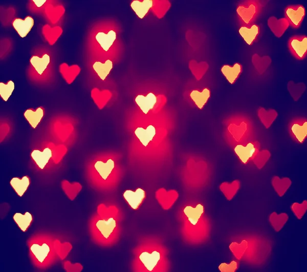 A nice background with defocused lights blurred into the shape of hearts good for holidays like valentine's day or wedding announcements or romantic cards — Stock Photo, Image