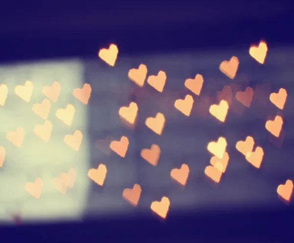 A nice background with defocused lights blurred into the shape of hearts good for holidays like valentine's day or wedding announcements or romantic cards — Stock Photo, Image