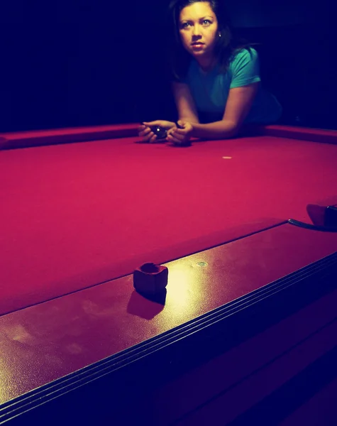 Girl leaning on pool table — Stock Photo, Image