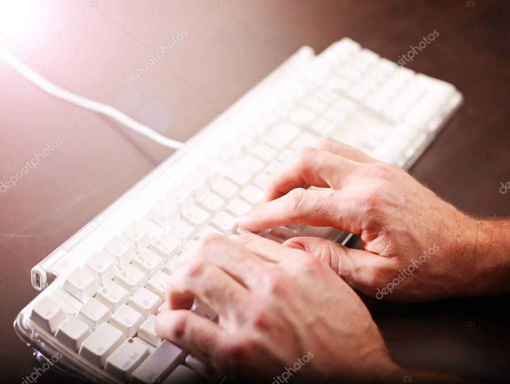 Hands typing on keyboard