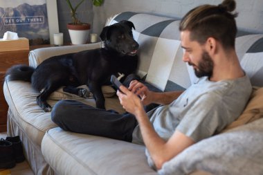 Pet owner hanging out with his dog clipart