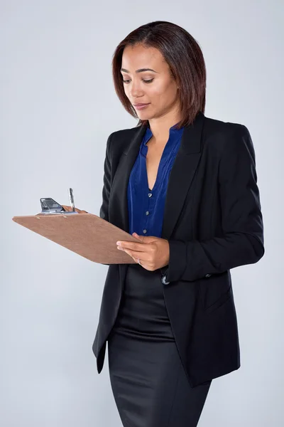 Business woman writing into an organiser — Stock Photo, Image