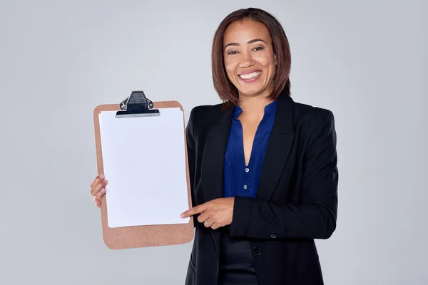 Business woman holding up empty clipboard — Stock Photo, Image