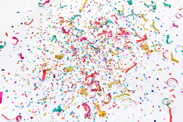 Colorful confetti on white floor — Stock Photo, Image