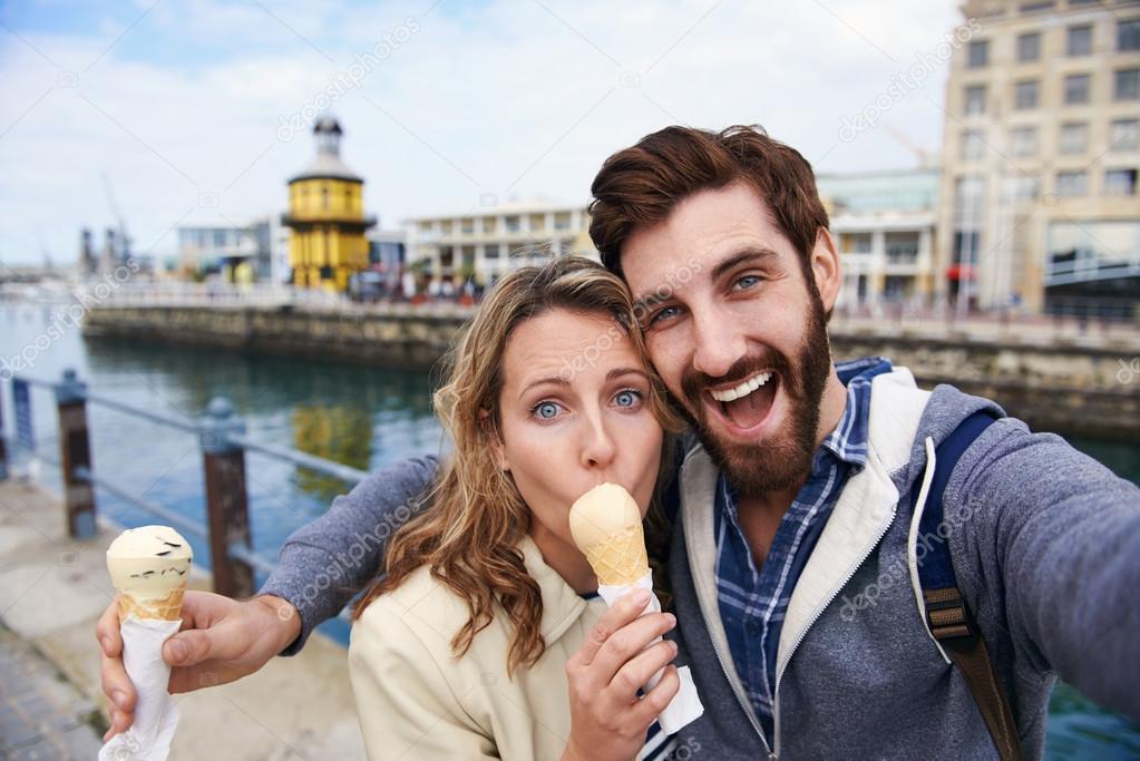Couple eating icecream taking selfie
