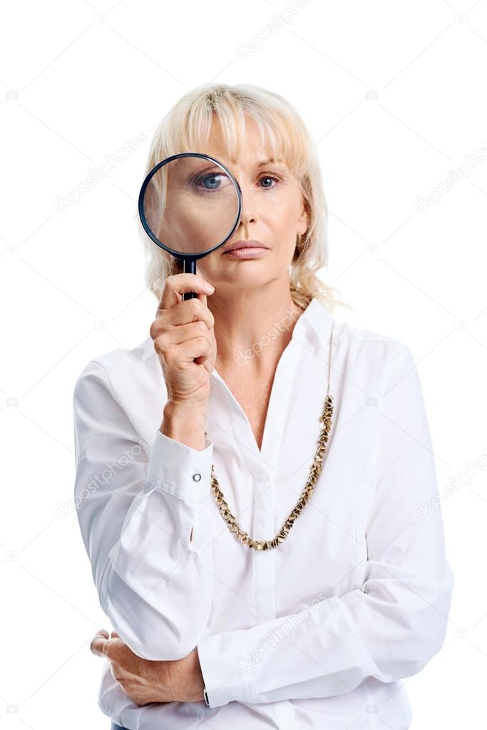 Woman serious holding magnifying glass