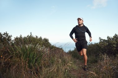 running man on mountain trail